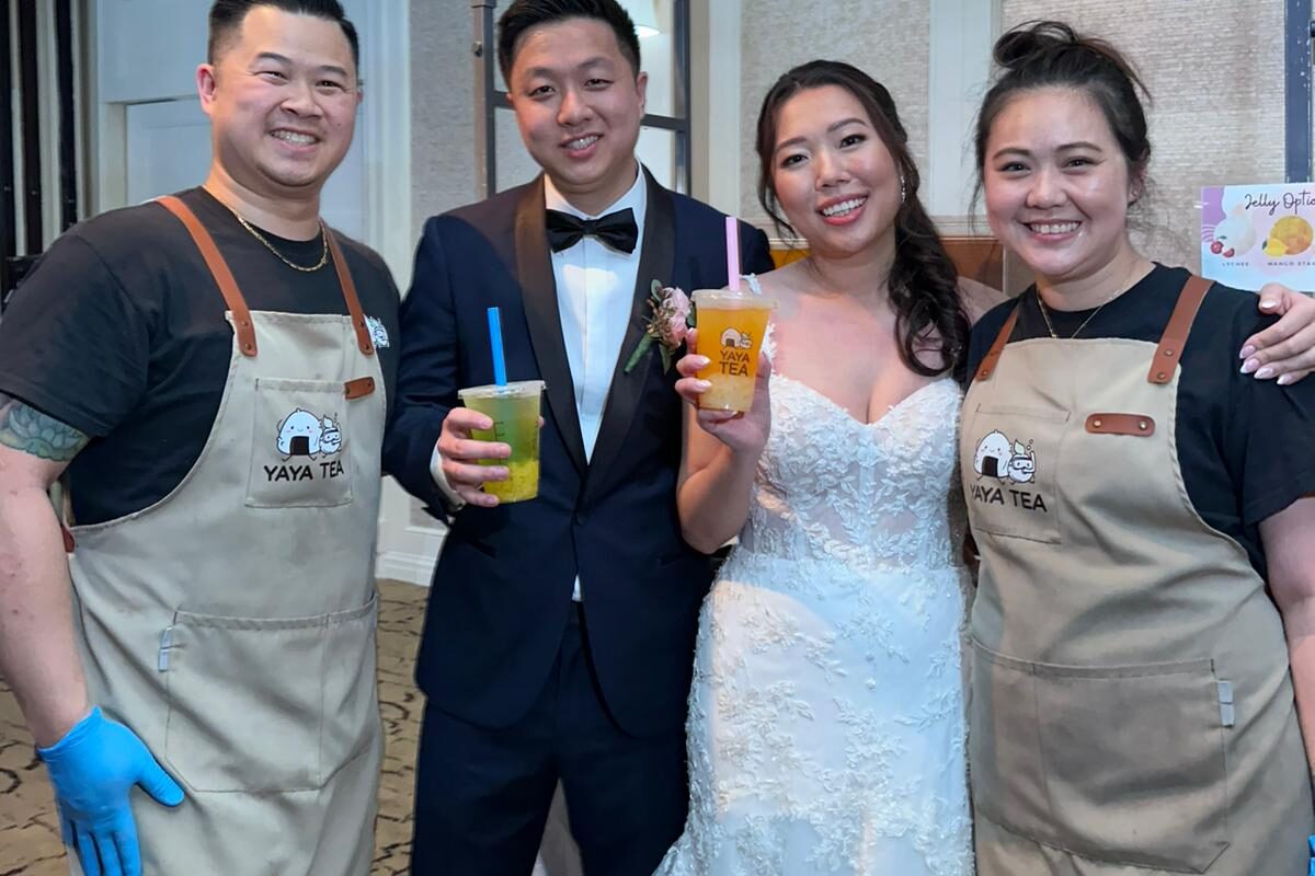 Yaya Tea staff serving fresh bubble tea to a bride and groom at a wedding reception.