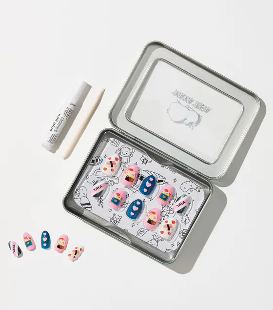 Yaya Tea x Claire's foodie press-on nail set in its collectible tin, with sushi, onigiri, and 'YAYA' nail designs